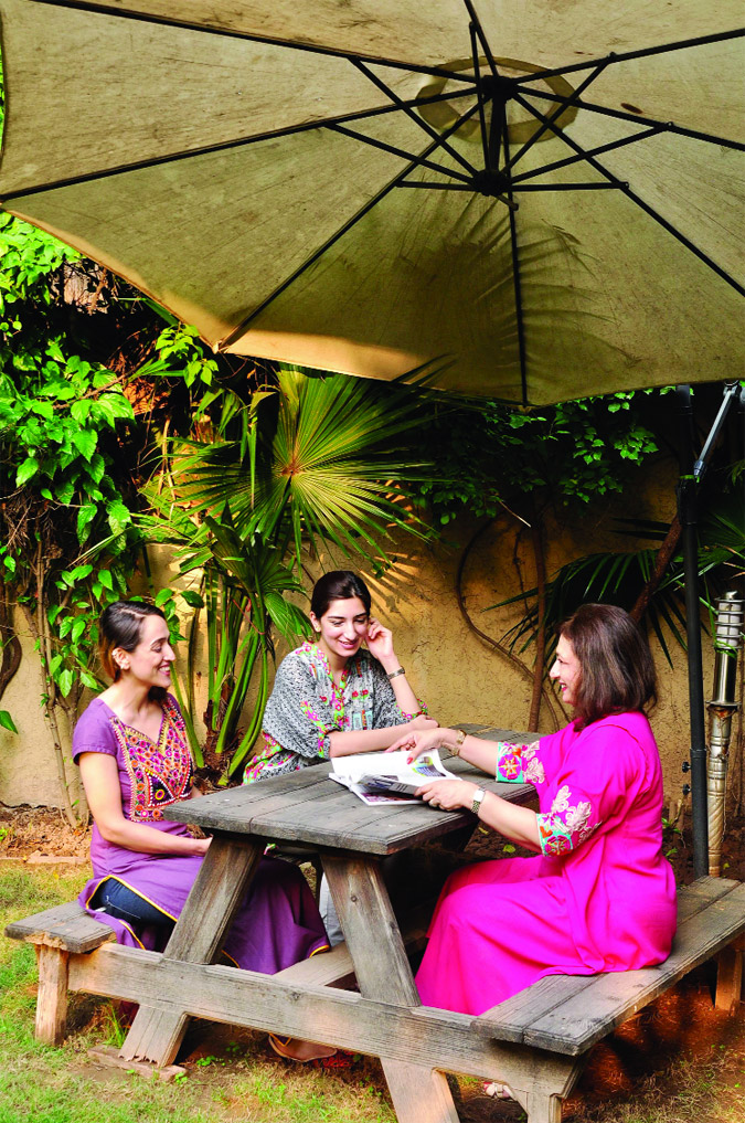 Nagin chatting with friends in the garden at Nomad